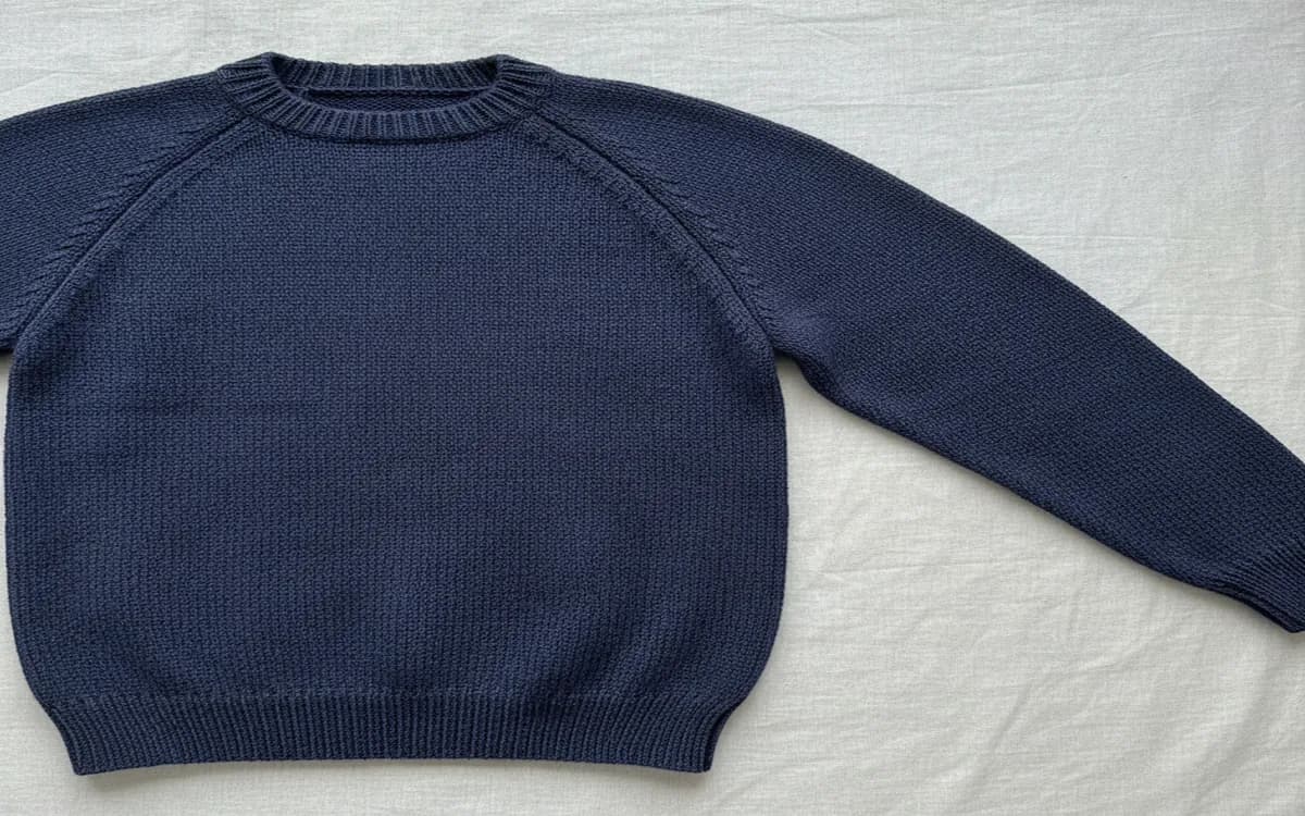 Set-in sleeve sweater showing tailored shoulder line and curved armhole seam